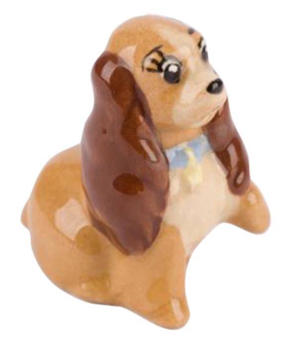 A "Lady and the Tramp" Figurine by Hagen Renaker.: (Hagen-Renaker, 1950s) A figurine of Lady from "Lady and the Tramp" by renowned Californian ceramist, Hagen Renaker. Measuring 1.5" tall, the ceramic figurine is in very good condition with minor