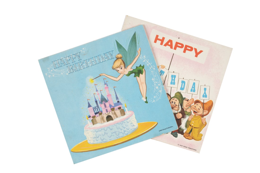 A Pair of Disney Buzza Cardo Happy Birthday Record Cards.: (Columbia, 1960s) A pair of Buzza Cardo Disney Birthday Record Cards featuring the authentic voices of Tinker Bell, Snow White, and more. Measuring 6" x 6", the cards with unpunched 33 1/3 rpm records