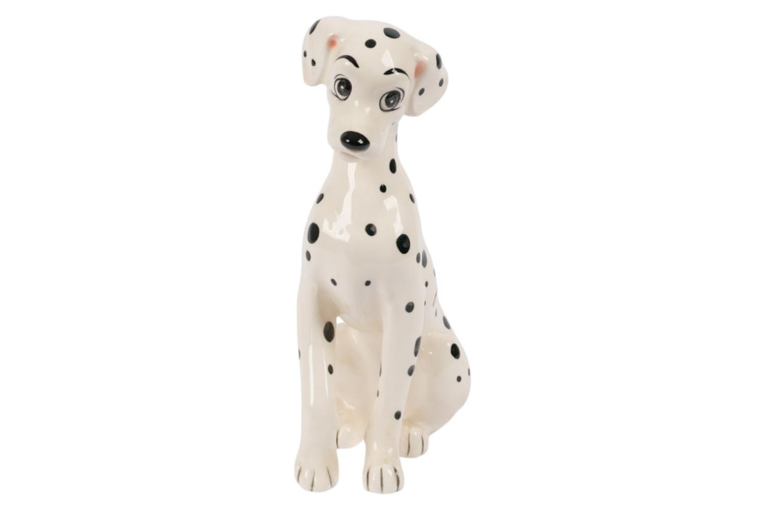 A "One Hundred and One Dalmatians" Perdita Figurine.: (Enesco, 1960s-70s) A ceramic figurine of Perdita from "One Hundred and One Dalmatians." Measuring 3" x 5.5" and 8.5" tall, the figurine is in very good condition with light wear from age and minor