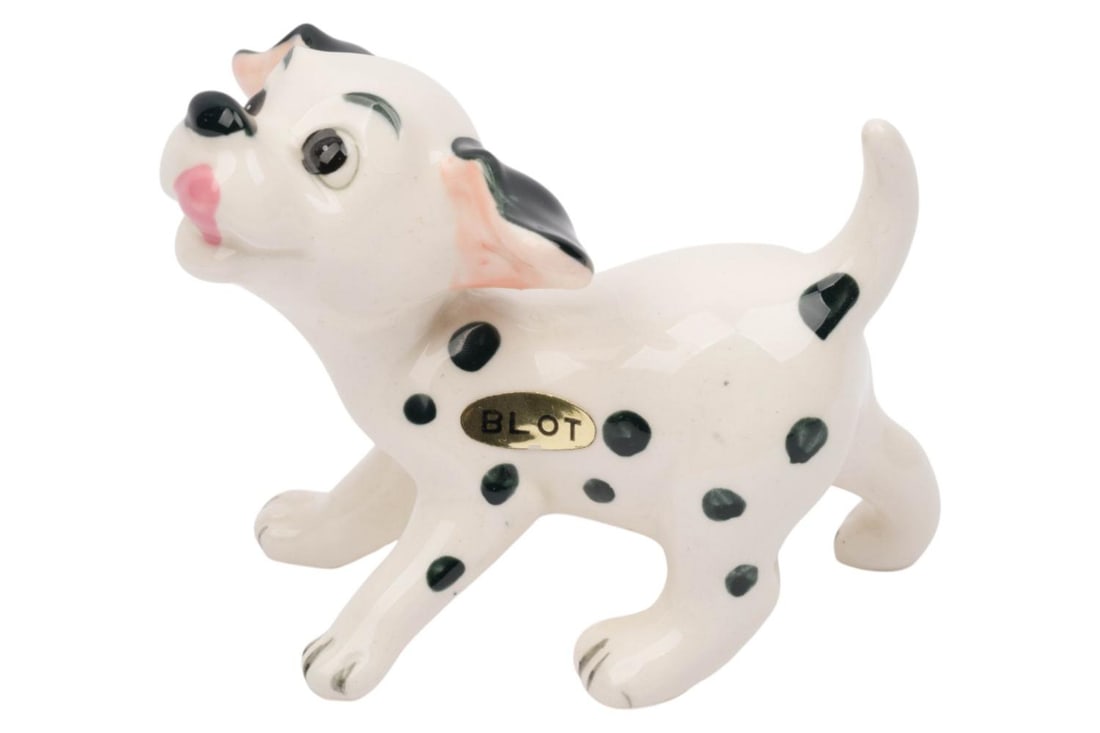A "One Hundred and One Dalmatians" Blot Figurine.: (Enesco, 1960s-70s) A ceramic figurine of the puppy Blot from "One Hundred and One Dalmatians." Measuring 3" x 5" and 4" tall, the figurine is in very good condition with minor crazing with adhesive