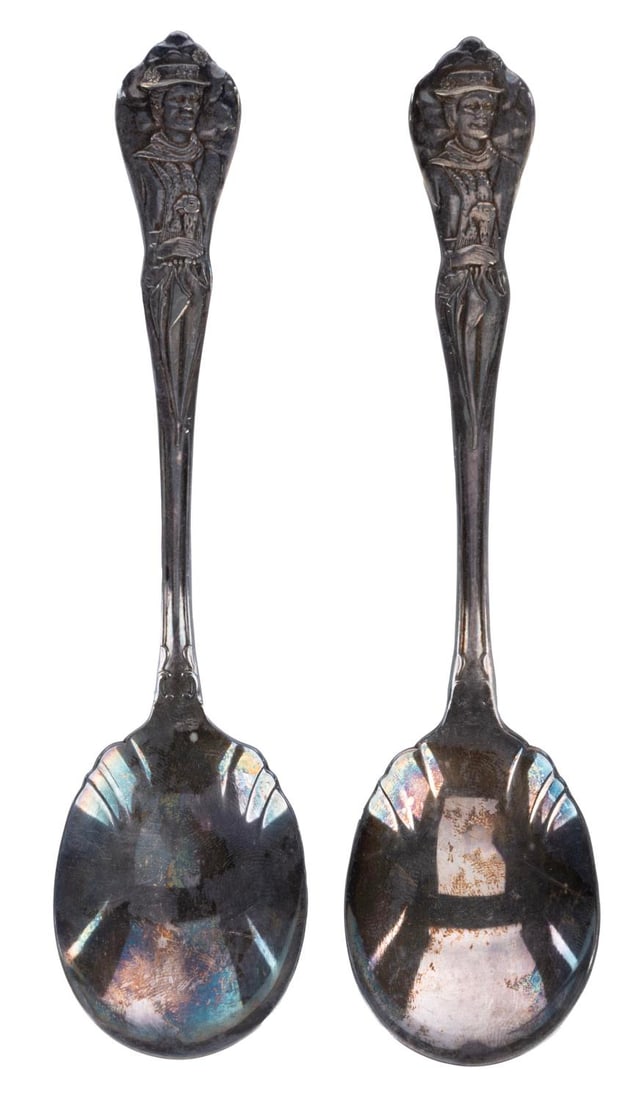 A Pair of "Mary Poppins" Silver-Plate Spoons..: (Oneida, 1964) Two "Mary Poppins" silver-plated spoons featuring Mary herself on the handle. Measuring 6" long, the spoons are in good condition with expected tarnishing throughout from age.