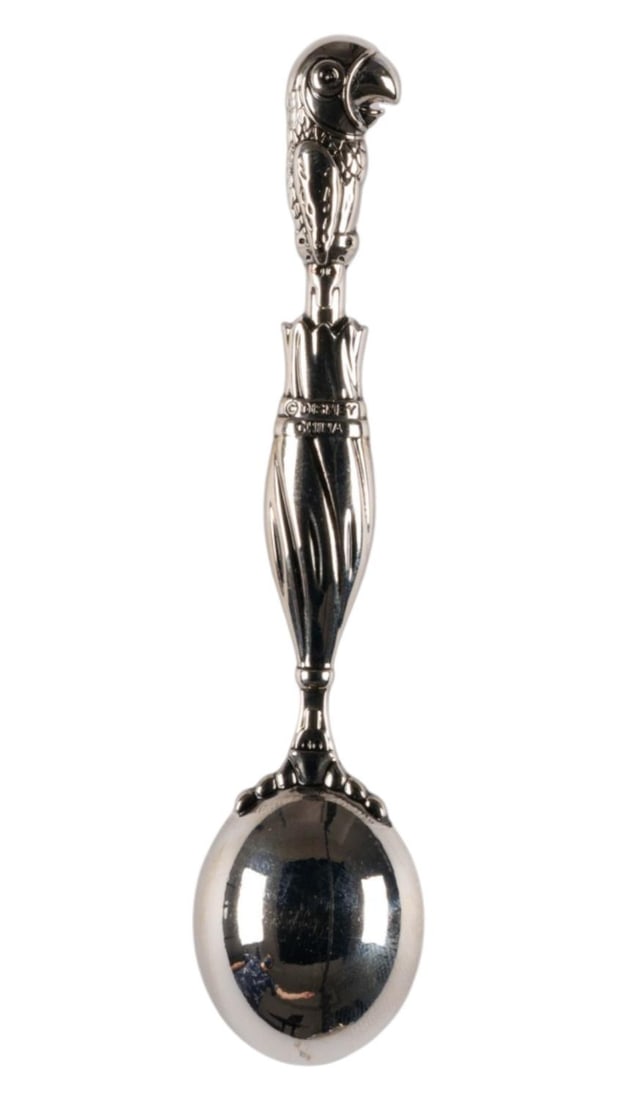 A Mary Poppins Parrot Head Umbrella Spoon.: (Disney Parks, 2010s) A "Mary Poppins" spoon with a relief of Mary's iconic Parrot Head Umbrella as the spoon's "stem," the spoon was likely manufactured after "Mary Poppins Returns" in 2018.
