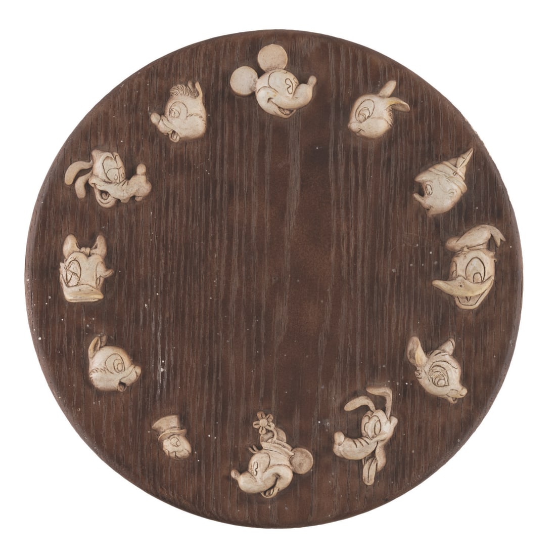 A Disney Characters Clock Prototype.: (Disney, 1970s-80s) A prototype wall clock featuring Disney characters, Mickey Mouse, Minnie, Goofy, Donald, Pluto, Daisy, Chip 'n' Dale, and characters from "Bambi" and "Pinocchio." Measuring 10.75"