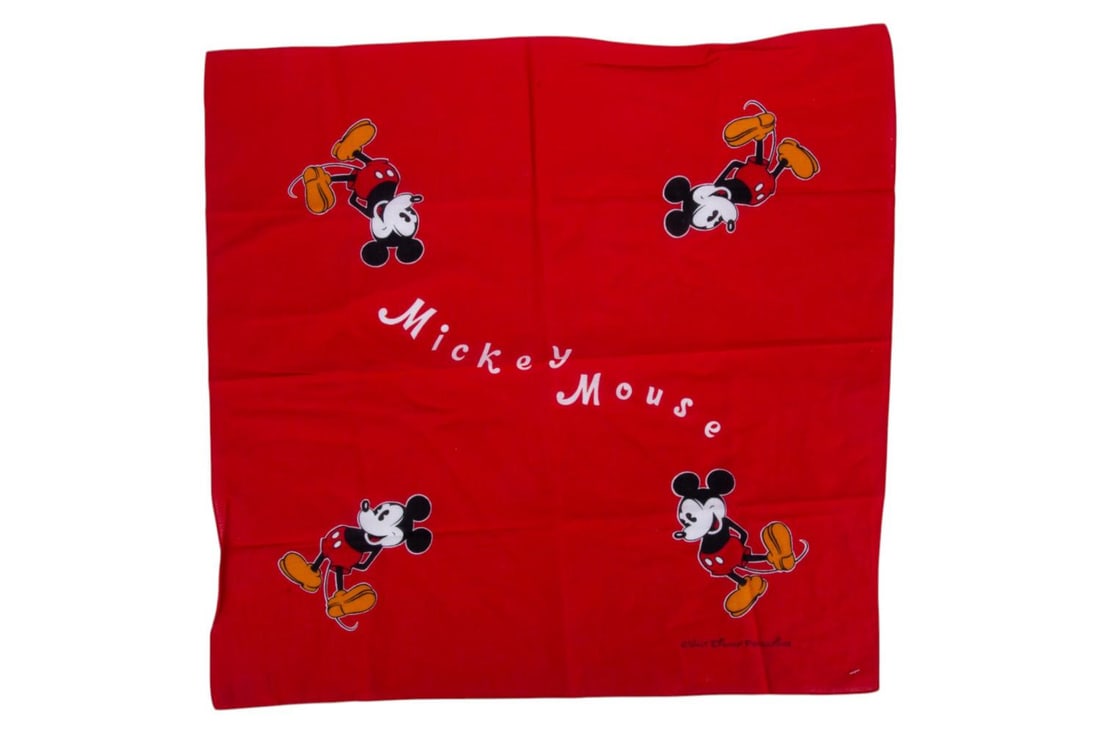 A Red Mickey Mouse Bandana.: (Disney, 1980s) A vibrant red bandana featuring Mickey Mouse on each of the four corners. Measuring 20" x 21", the bandana is in fine condition.