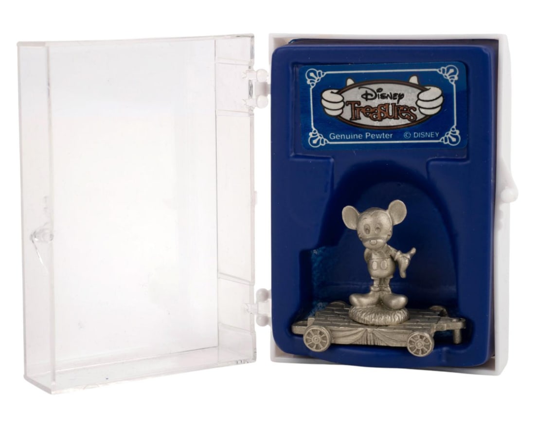 A Disney Treasures Mickey Mouse Pewter Miniature Train Figure.: (Disney, 1980s-90s) A miniature train featuring Mickey Mouse standing aboard a pewter train car. The figurine was released by Disney Treasures as part of a larger set. Measuring 1.5" x 1.25" and
