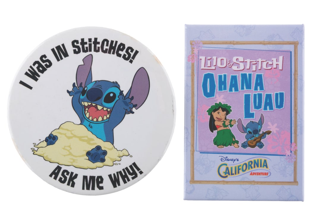 A Pair of Early "Lilo & Stitch" Buttons.: (Disney, 2000s) A pair of early "Lilo and Stitch" buttons. Included are an "I Was In Stitches" button given away at early screenings, and a button for the Ohana Luau show in California Adventure in 20