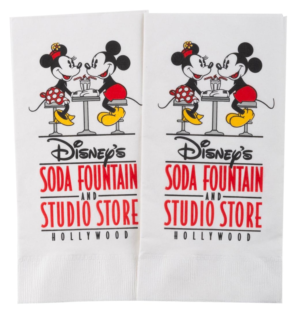 A Pair of Disney's Soda Fountain and Studio Store Napkins.: (Disney, 2005) A pair of napkins from Disney's Soda Fountain and Studio Store next to the El Capitan Theater in Hollywood. Measuring 4.25" x 8.5", the napkins are in good condition with light