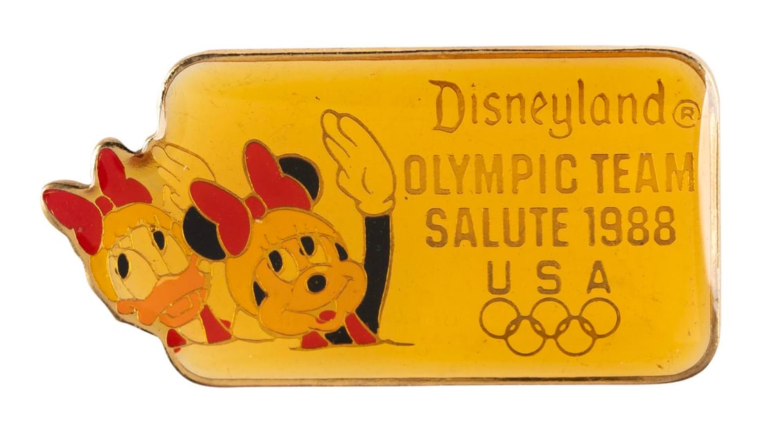 A Minnie and Daisy Olympic Synchronized Swimming Pin.: (Disneyland, 1988) A Disneyland Olympic Team Salute 1988 pin, featuring Minnie Mouse and Daisy Duck as synchronized swimmers. Measuring 1.5" wide, the pin is in very good condition with color shift