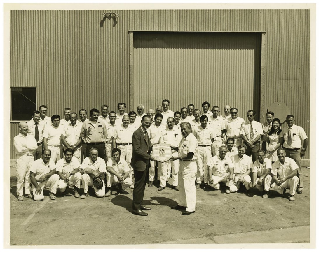 A Maintenance & Engineering Cast Member Group Photo.: (Disneyland, 1970) A black and white Cast Member award photo for Dave Hauenstein of Disneyland's Maintenance and Engineering department. The photo depicts members of the department during an award