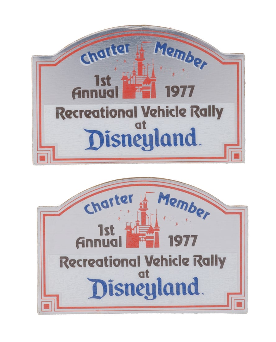 A Pair of Charter Member Disneyland RV Rally Emblems.: (Disneyland, 1977) A pair of plaque-style decals from the Disneyland Recreational Vehicle Rally. Featuring printed text on a reflective background that reads "1st Annual 1977 Recreational Rally