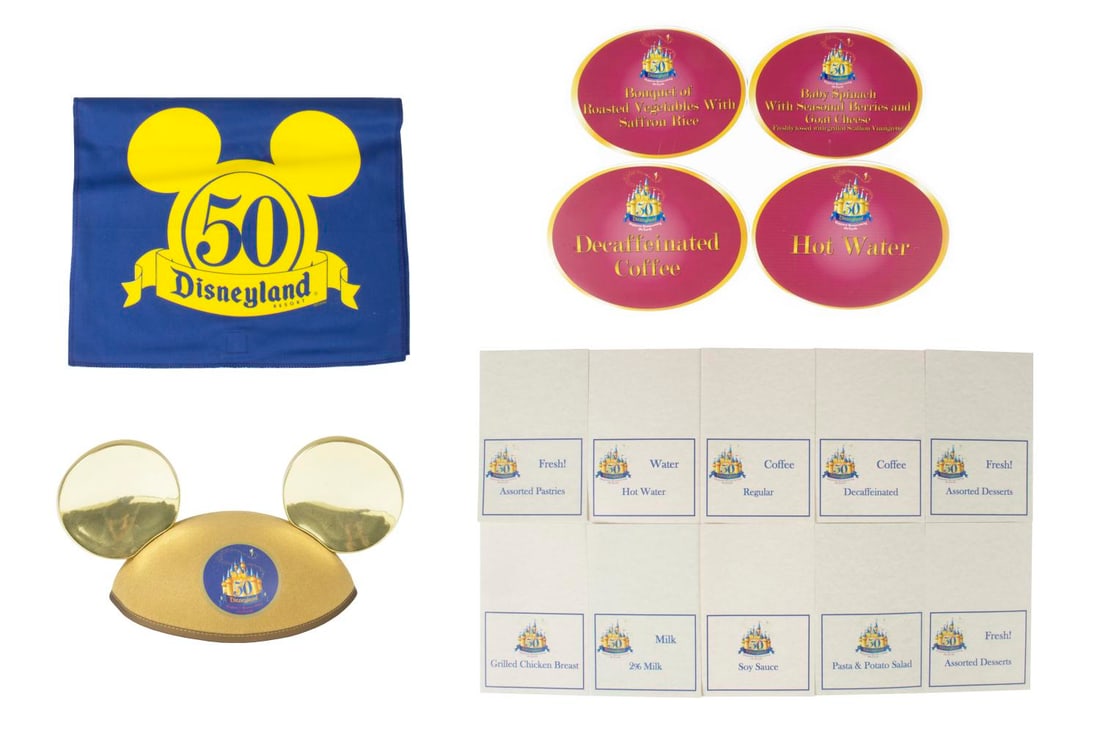 A Collection of Disneyland 50th Anniversary Event Display Signs.: (Disneyland, 2005) A collection of Park-used signs and souvenirs from Disneyland's 50th Anniversary year in 2005. Included are four menu signs for food and drink options, ten paper menu cards with