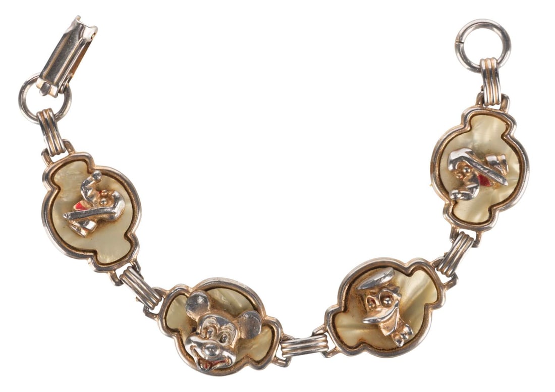 A Rare Disney Children's Bracelet.: (Disney, 1950s-60s) A rare children's bracelet featuring four mother-of-pearl charms with Mickey Mouse, Donald Duck, and two of Pluto. Measuring 5" long, the bracelet displays in good condition with o