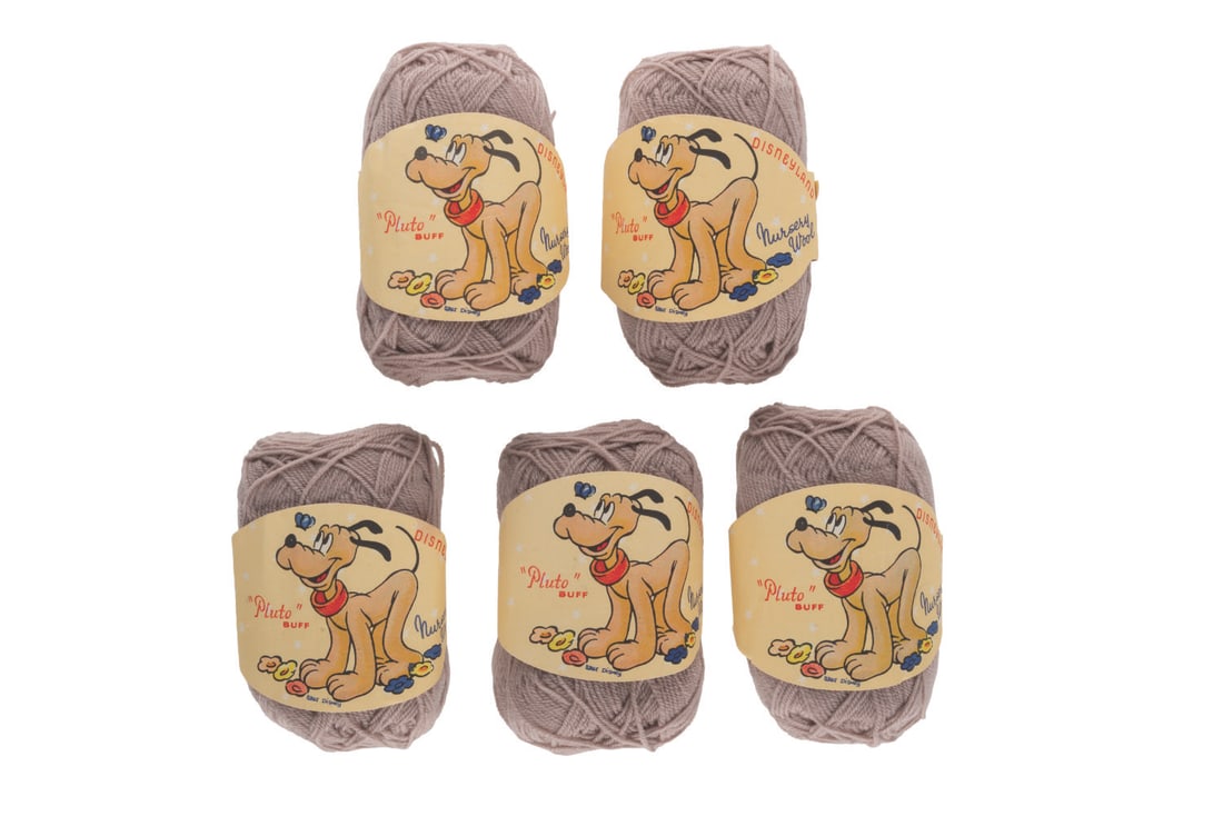 A Collection of Disneyland Nursery Wools.: (Disneyland, 1960s) Five one-ounce balls of Disneyland Nursery Wools. These originally came in 26 colors, each with a different Disney character on the label. This set features five beige-colored