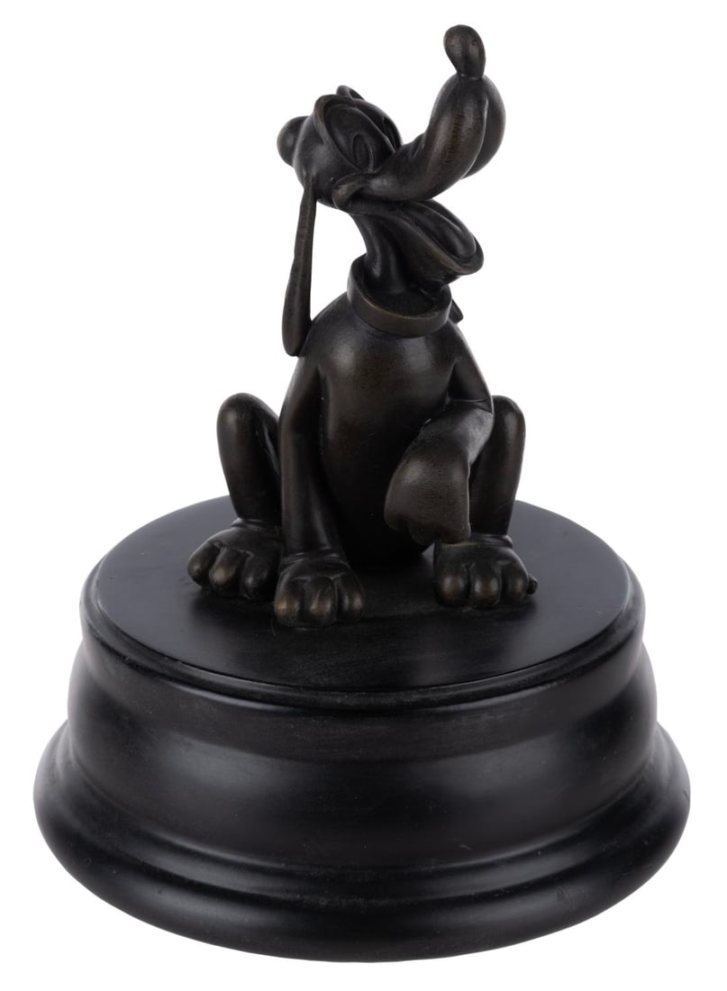 A Disneyland Hub Pluto Bronze Collectible.: (Disney, 2000s) A bronze replica of the Pluto statue on display in the hub in front of Sleeping Beauty Castle at Disneyland. Measuring 6.5" tall and 5" in diameter, the statue is in very good conditio