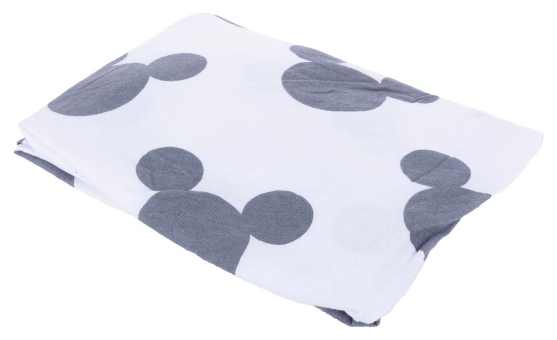 A Walt Disney World Mickey Mouse Crib Sheet.: (Walt Disney World, 2000s) A crib sheet featuring a Mickey Mouse head motif used at several resorts across the Walt Disney World Resort. Measuring 19.5" x 30", the sheet is in very good condition