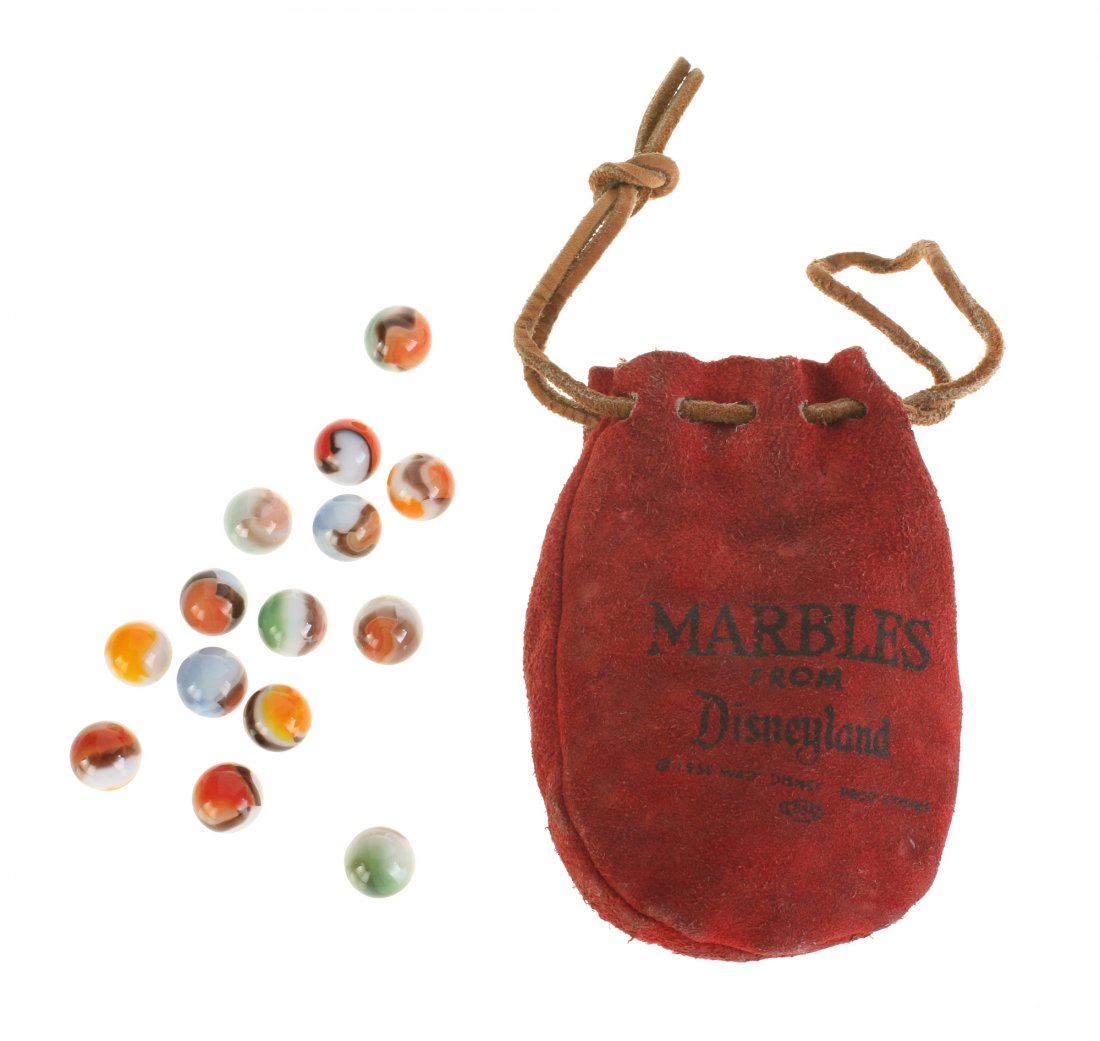 "Marbles from Disneyland" in Original Leather Pouch.: (Disneyland, 1955) Red leather pouch that reads "Marbles from Disneyland" and is dated 1955. Comes with (14) vintage-looking glass marbles, which may not be original to the pouch. Measures 5.25"x3.75"