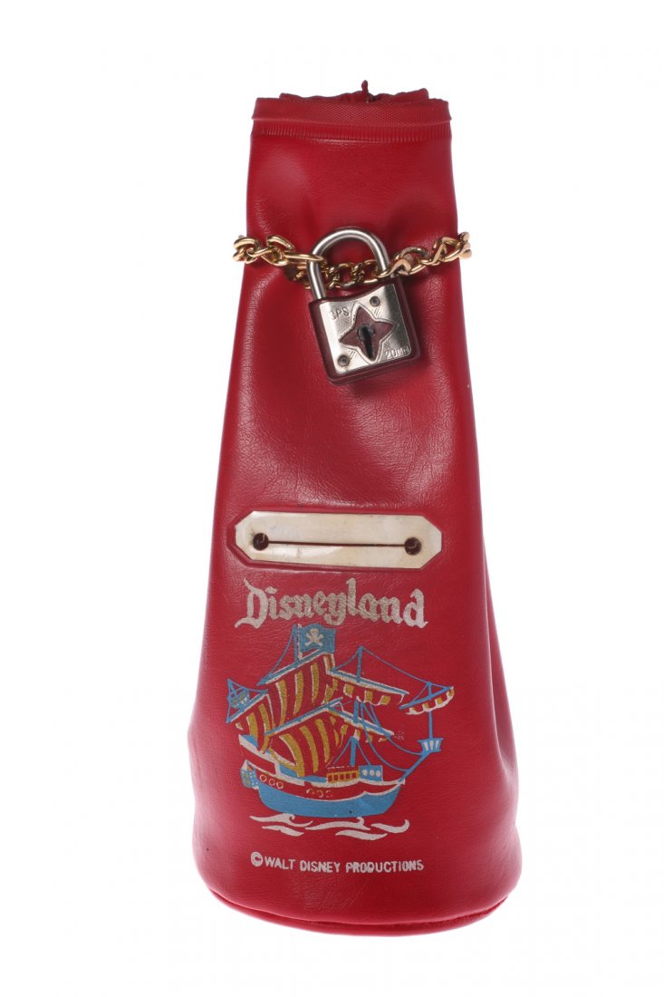 Disneyland Pirate Ship Money Bag Bank.: (Disneyland, 1950s) Red vinyl money bag bank featuring pirate ship imagery on the front below the text "Disneyland". A chain and lock closes the top of the bag and a slit in the middle allows for coin