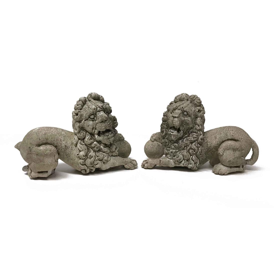 Fantastic Pair of Vintage Stone Cast Medici Lions: Fantastic Pair of Vintage Stone Cast Medici Lions. Great patina and age and acid rain etching. Two small lions laying with a sphere or ball under one paw looking to the side. Matched opposing pair. On