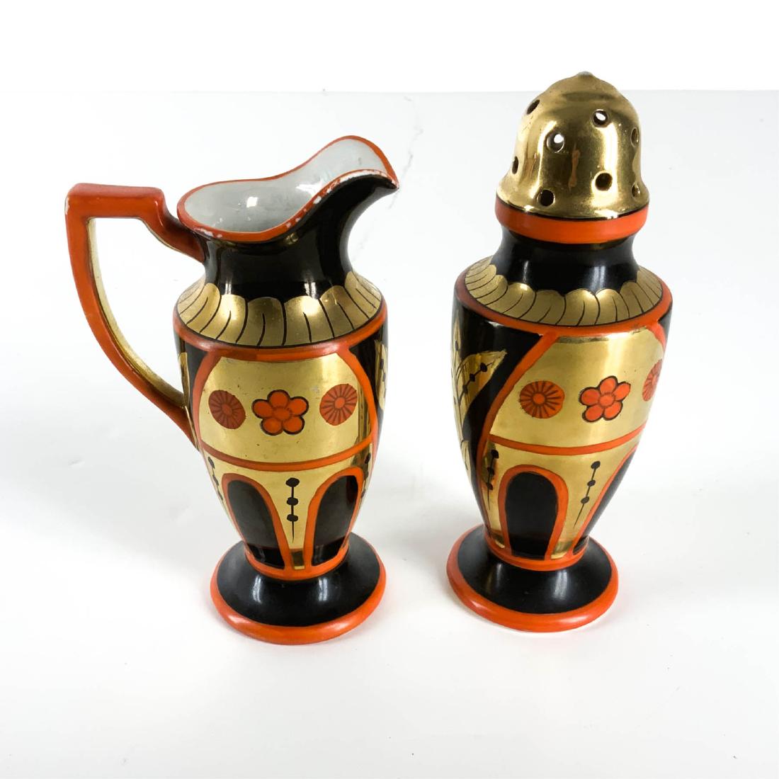 Noritake Hand Painted Gilt Sugar Creamer Set: Antique Noritake Hand Painted Sugar and Creamer Set Marked Made in Japan, overall good condition, some loss to edge of creamer. Sugar 6.5H x 2.25W Creamer 5.75H x 3.5W