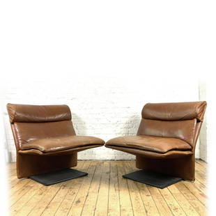 Pair of Italian Mid Century Leather Chairs: Pair of what we believe to be mid century leather chairs from Italy. Heavy steel plate frame in a cantilever style. Very unusual, owner purchased in Los Angelesfor $5,000 in 1998 and was told they wer