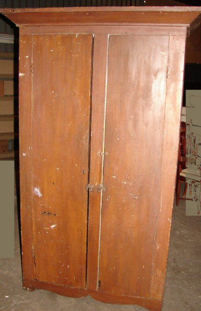 Antique Primitive Tall Pine Cupboard: Approximately 7' tall by 40" wide by 22" deep. Primitive cupboard with two doors, original crown molding top and original crackled brown paint, ca 1840. From the dairy farm home of Frank Norton, Woodr
