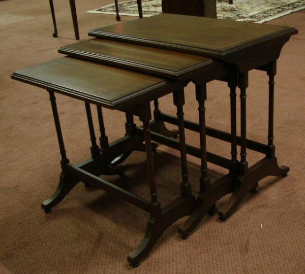 Set of Three Brandt Nesting Tables: Stretcher base, Duncan Phyfe style. Top table is satinwood inlaid. Good condition, Brandt label. Measurements: Top table 15" (w) x 24" (l) x 21 3/4" (t).