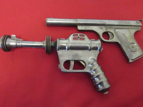 Vintage Buck Rogers Gun and Daisy Pistol: -Buck Rogers U-235 Atomic Pistol. The gun has a fluted barrel, flamboyant fins and a ‘blue steel’ finish; with the red "Fission Control Chamber." Made by Daisy in the 1940’s-Daisy Target Special