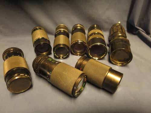 Box of camera lenses, multiple brands and sizes. (1 of 7)