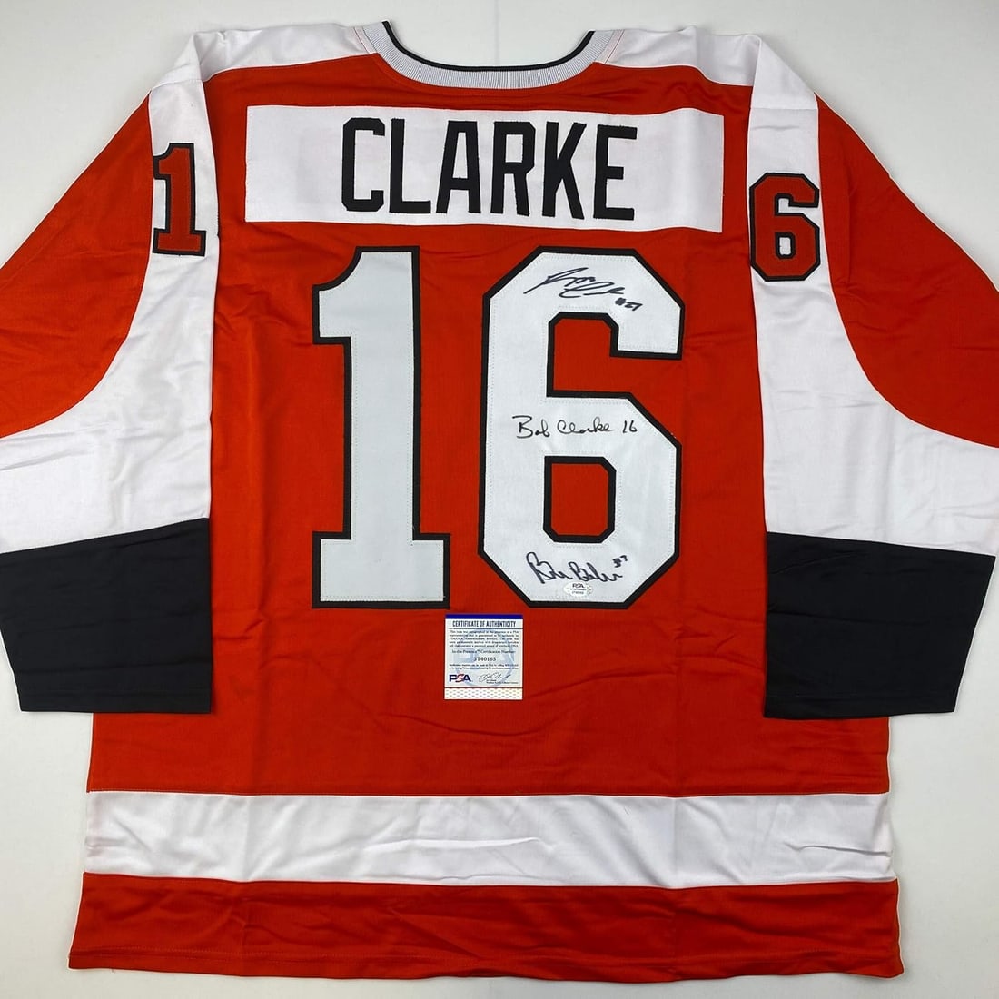 Autographed/Signed Reggie Leach, Bobby Clarke & Bill Barber Orange Jersey PSA/DNA COA: Item will come with a trusted third party certificate of authenticity and/or authentication hologram from PSA, JSA, Beckett, Fanatics, Steiner Sports, Panini, Tristar, or Upper Deck.