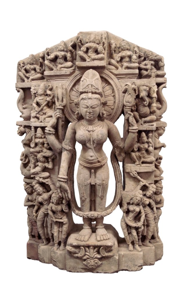 An Indian buff sandstone stele of Parvati, 16th: An Indian buff sandstone stele of Parvati, 16th century, standing in elegant tribhanga wearing a long dhoti secured with a beaded festooned belt, the sacred thread about his torso, adorned with multip