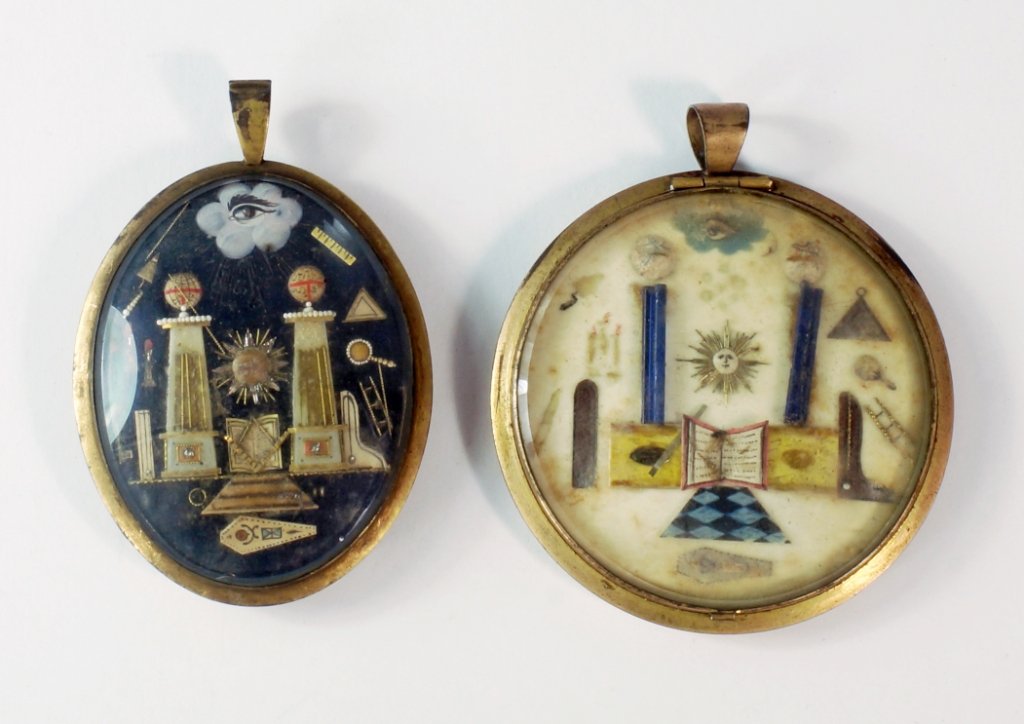 A French Napoleonic prisoner of war Masonic pendant,: A French Napoleonic prisoner of war Masonic pendant, c.1805, central glazed Masonic motifs, within oval pendant, 5 cm hight, together with another round example similar, (2).