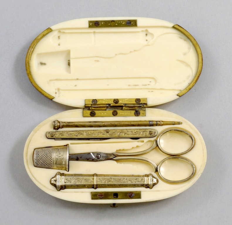 A French ivory cased silver nécessaire, comprising: A French ivory cased silver nécessaire, comprising pencil, penknife, scissors, thimble and needle case, the hinge marked Brevetté, approx 11.5cm wide.