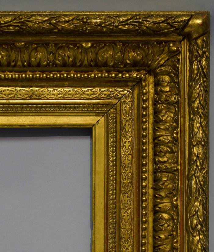 A Gilt Composition Louis XVI Style Frame, late 19th: A Gilt Composition Louis XVI Style Frame, late 19th century, with cavetto sight, leaf and dart, schematic leaf course, pearl bead, acanthus to the ogee and leaf and berry with tied corners to the toru
