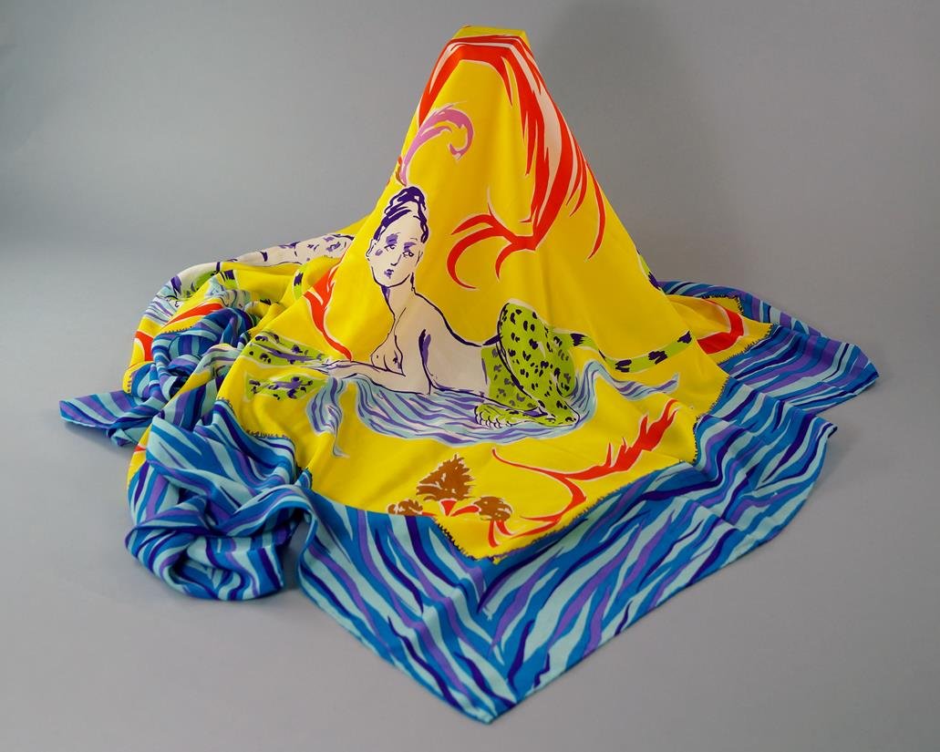 A collection of scarves, including Christian Lacroix,: A collection of scarves, including Christian Lacroix, Sphinx design, approx 138cm x 136cm, a large Yves Saint Laurent silk scarf, red roses on a black ground, approx 130cm x 127cm, another identical s