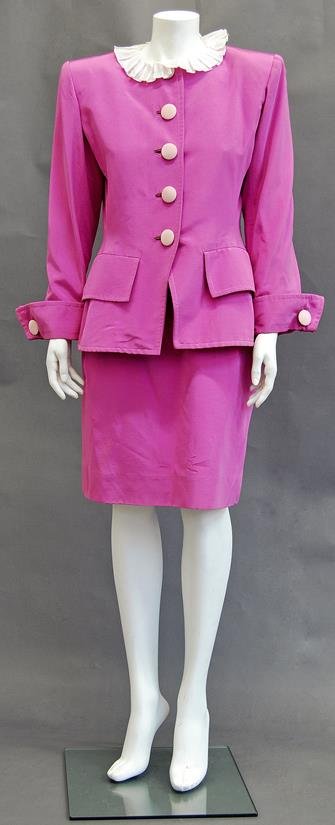 Yves Saint Laurent: A cerise two piece jacket and skirt: Yves Saint Laurent: A cerise two piece jacket and skirt suit, 1980s, the fitted jacket with two detachable white ruffs and large contrasting buttons, turn-back cuffs with button detailing, the pencil 