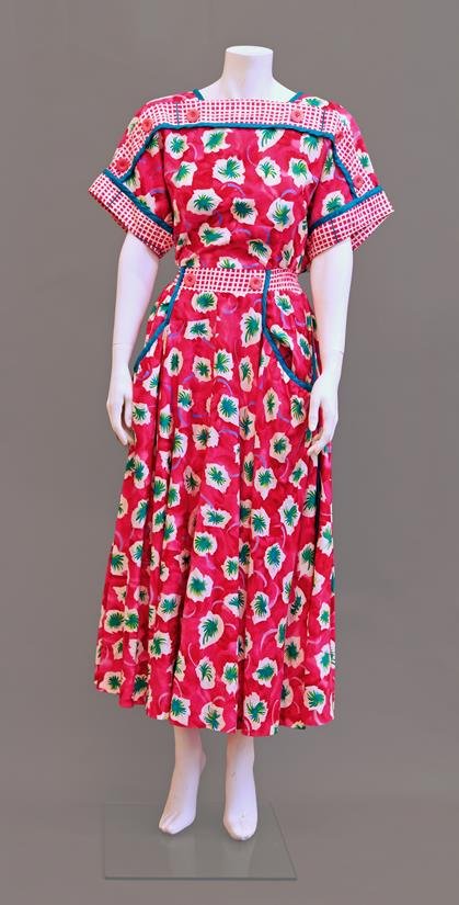 A 1950s style pink floral print dress by Jeanne Marc,: A 1950s style pink floral print dress by Jeanne Marc, with button detailing to the yoke and shoulders, front patch pockets and full shirt, also a 1950s grey quilted satin gown with shocking pink lace 