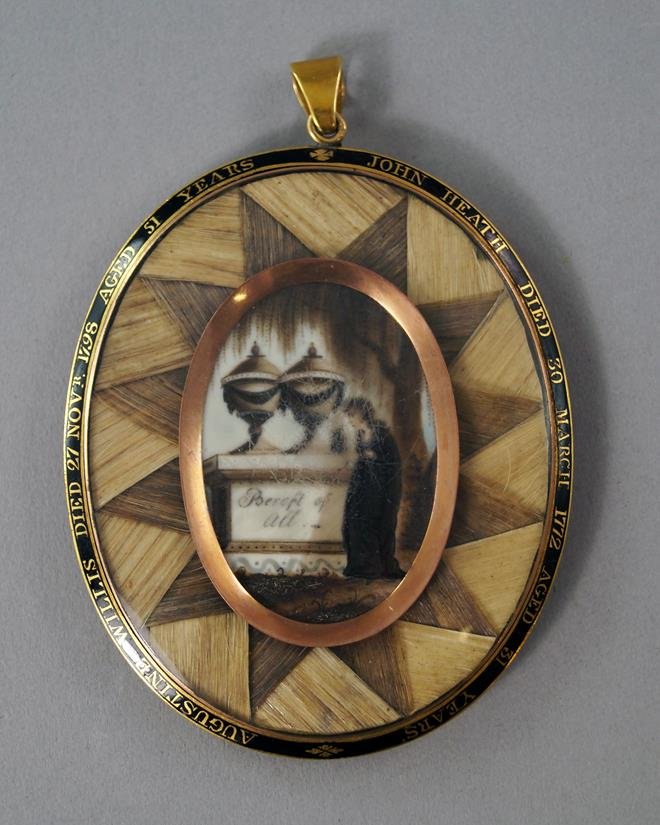 A George III oval commemorative memento mori medallion,: A George III oval commemorative memento mori medallion, with central oval picture of a maiden mourning at a grave, surmounted by classical urns, surrounded by a band of geometrically arranged hair, th