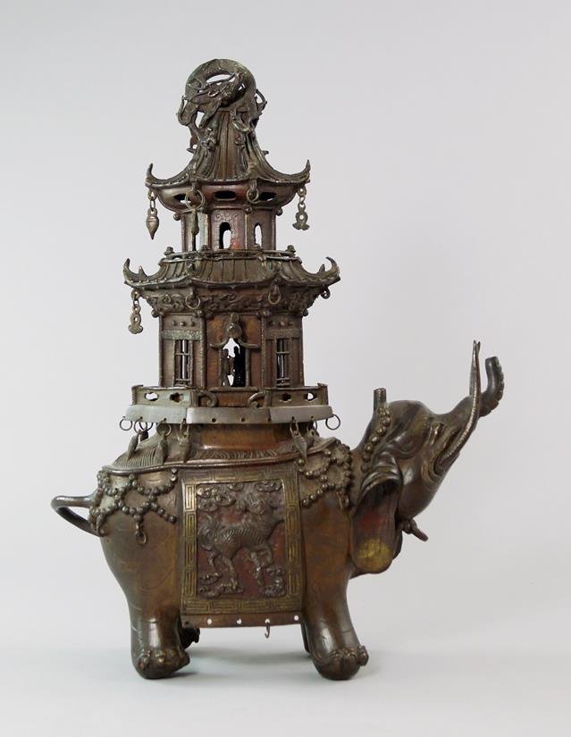 A Japanese bronze incense burner, in the form of an: A Japanese bronze incense burner, in the form of an elephant, 19th century, the lid of pagoda form, 38cm. high