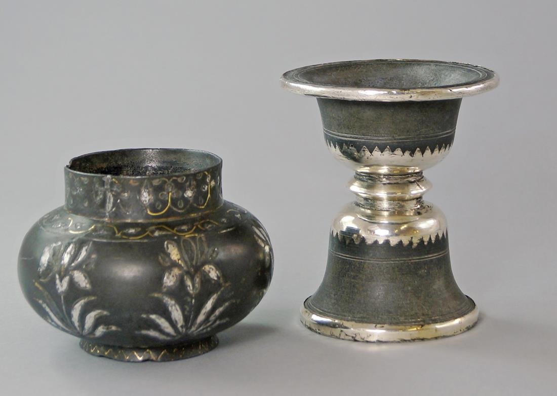 A Bidriware spittoon, 19th century, 11.2cm. high,: A Bidriware spittoon, 19th century, 11.2cm. high, together with a bellied bidriware jar, inlaid with stylised flowers, 8.2cm. high(2)