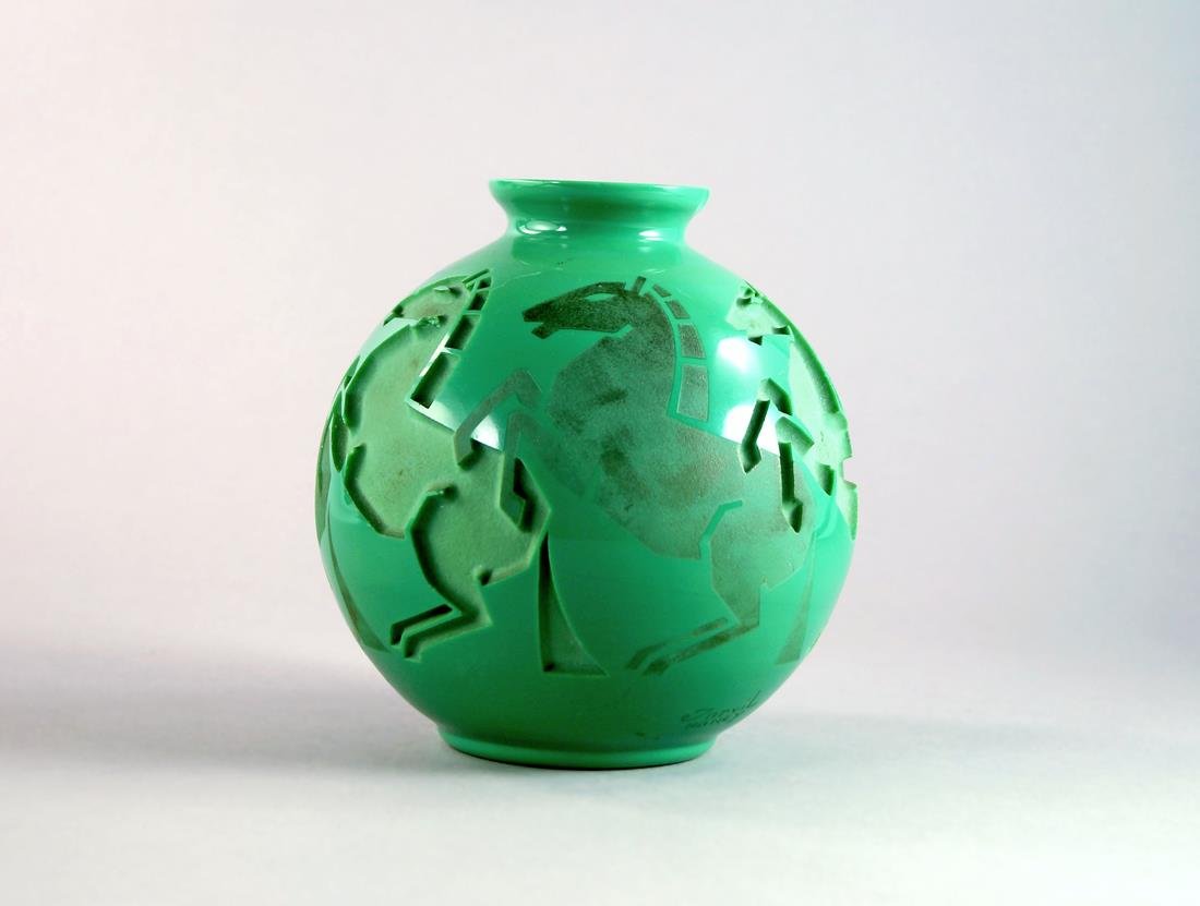 An Andre Delatte glass vase c.1930, the opaque green: An Andre Delatte glass vase c.1930, the opaque green globular body with a band of inset moulded and etched horses, etched marks Jarvil Nancy to side, 16cm high