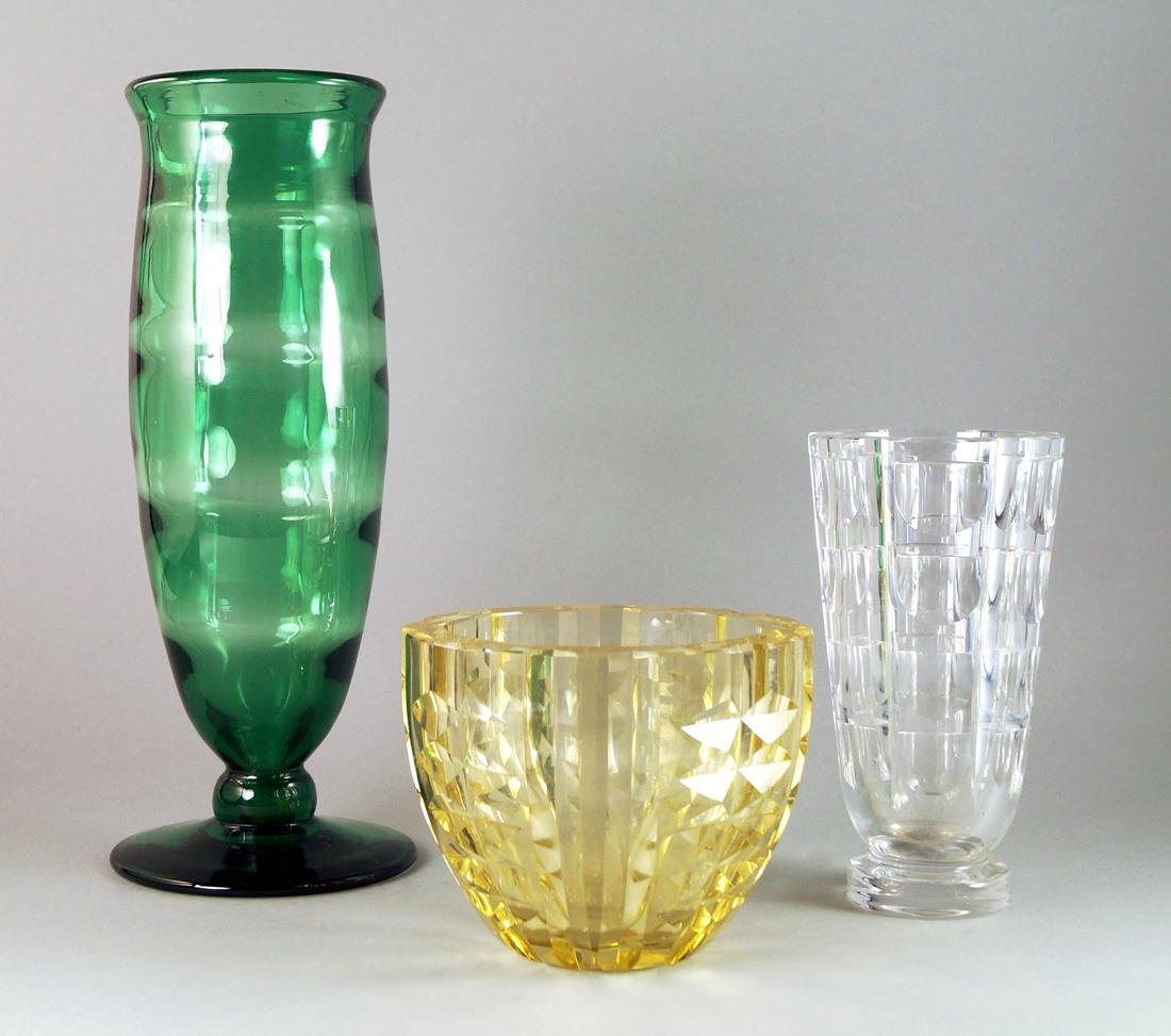 Attributed to Elis Bergh, Swedish 1881-1954 for Boda,: Attributed to Elis Bergh, Swedish 1881-1954 for Boda, Sweden, a footed green glass optic vase, c.1930, 34.5cm high: together with two facet cut Swedish glass vases, one signed Orrefors, 19.5 cm and 12