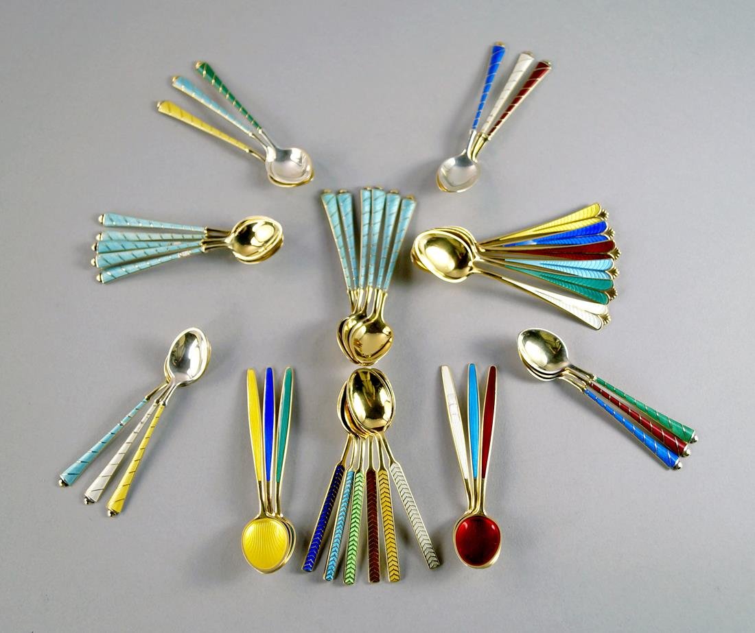 A collection of silver vermeil and enamel coffee: A collection of silver vermeil and enamel coffee spoons, to include two sets of six by David Andersen, Norway, a set of six by Meka, Denmark, together with four further sets of six, ELA Denmark, impor