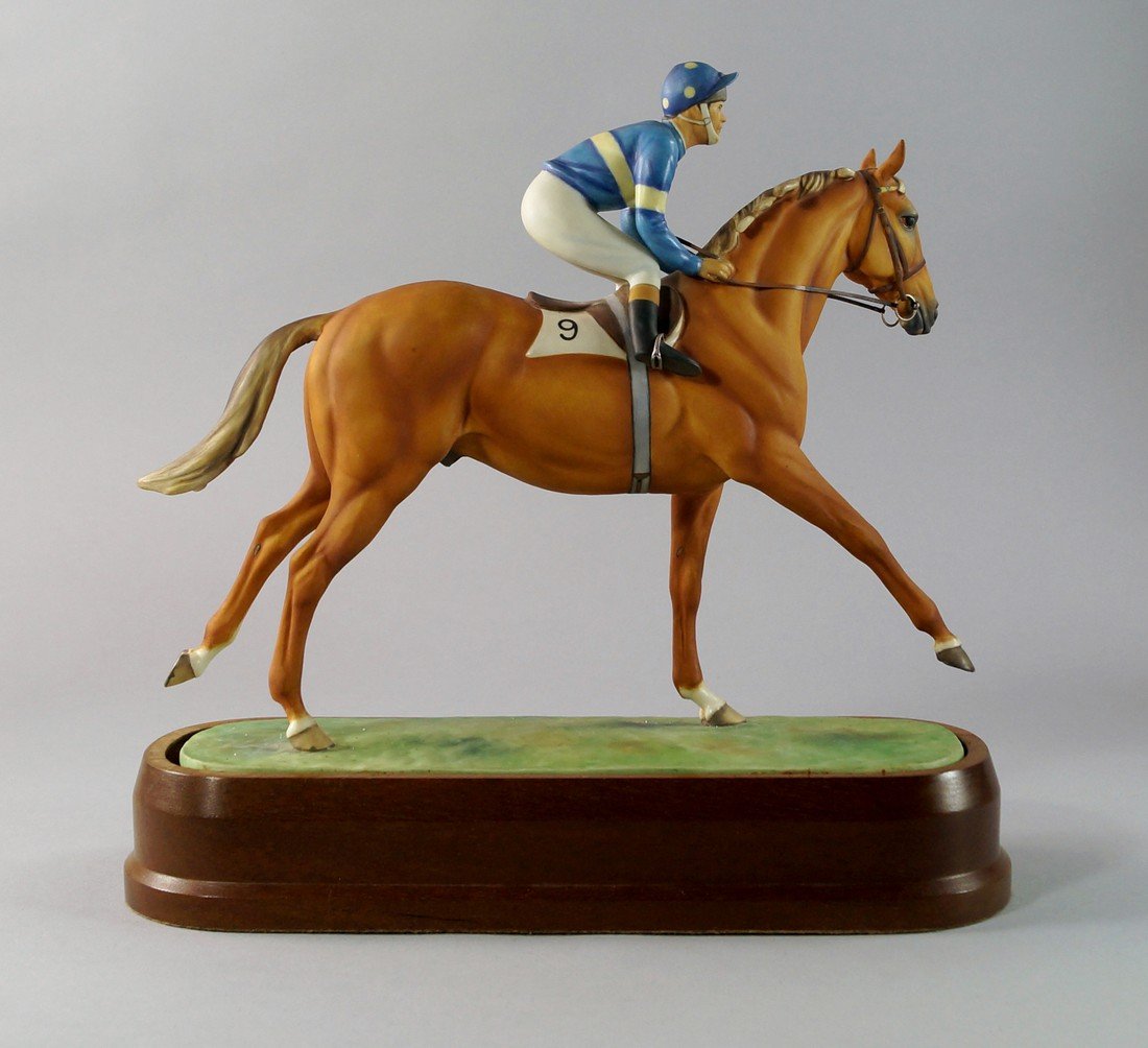 A Royal Worcester model of Grundy and Pat Eddery by: A Royal Worcester model of Grundy and Pat Eddery by Doris Lindner, 1976, modelled as jockey on horse on a green base, mounted on a wooden plinth, bears factory mark to base, together with certificate