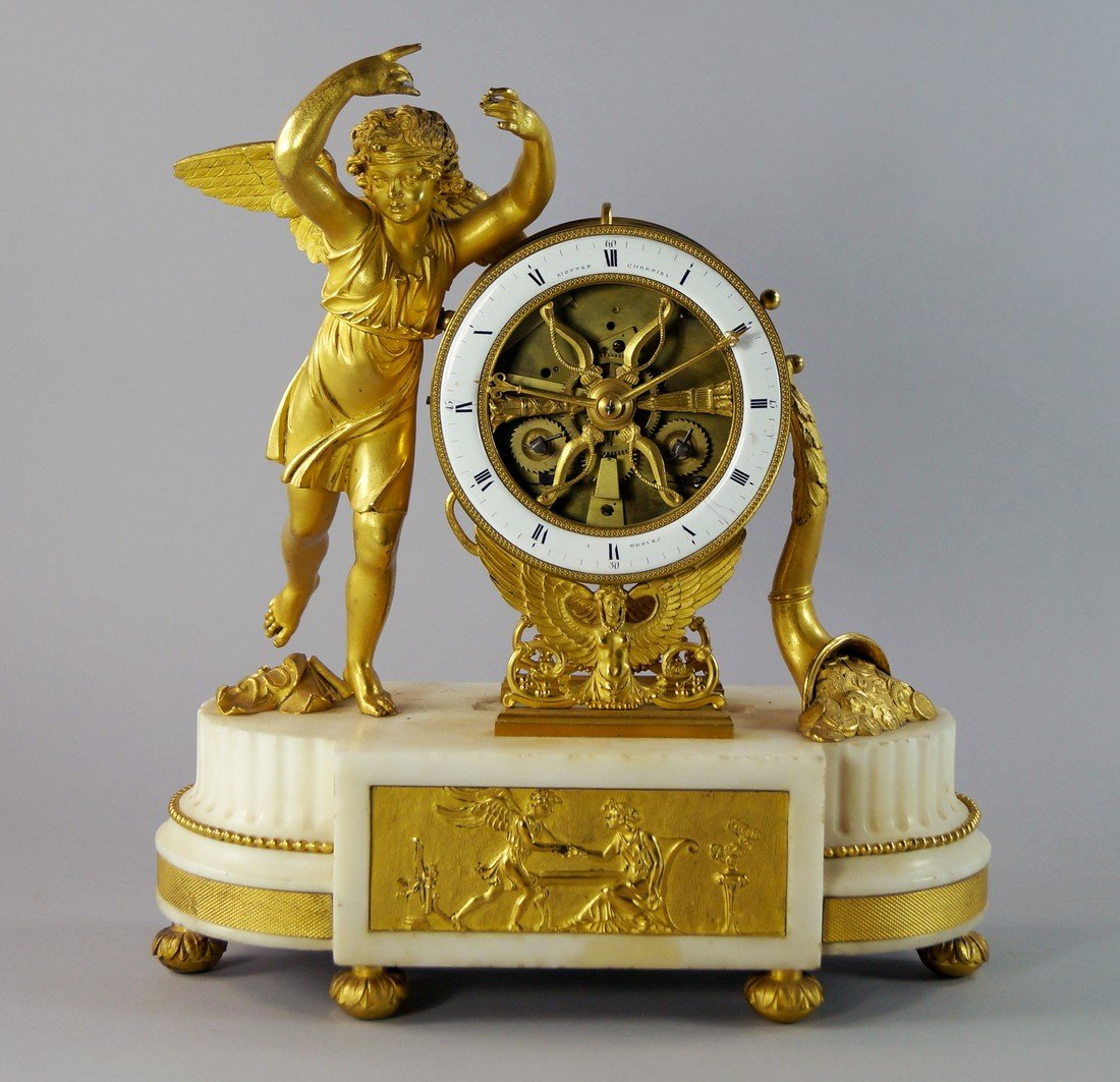 A French ormolu and white marble mantel clock, 19th: A French ormolu and white marble mantel clock, 19th century, the movement contained in a barrel case on winged figural supports, flanked by a classically dressed dancing cherub and a coin filled cornu