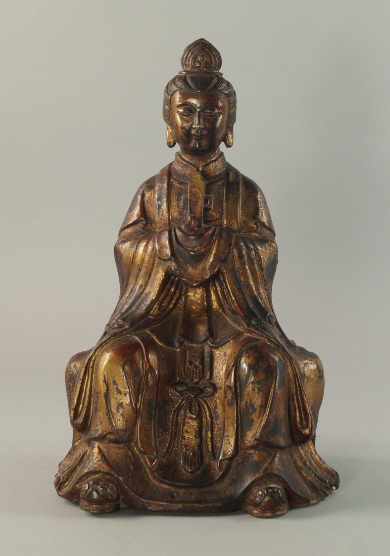 A Chinese Ming style bronze figure of an official, late: A Chinese Ming style bronze figure of an official, late 19th/20th century, modelled wearing a robe holding a tablet, the surface showing signs of lacquer and gilding, 32cm high
