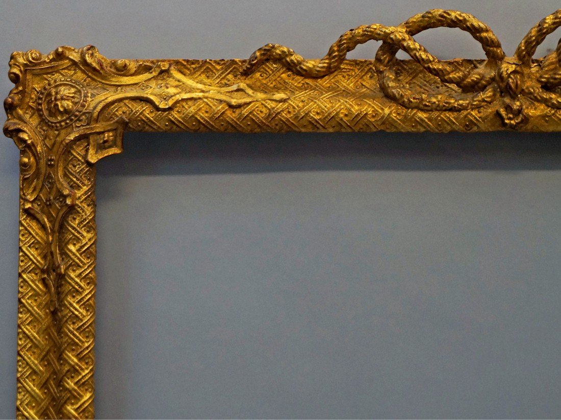 A Gilt Composition Moorish Inspired Frame, mid-late: A Gilt Composition Moorish Inspired Frame, mid-late 19th century, the reverse ogee with diapered ground and flower heads, wit rope twist centres and cartouche corners, 81.5x64cm: A Gilt Composition Fr