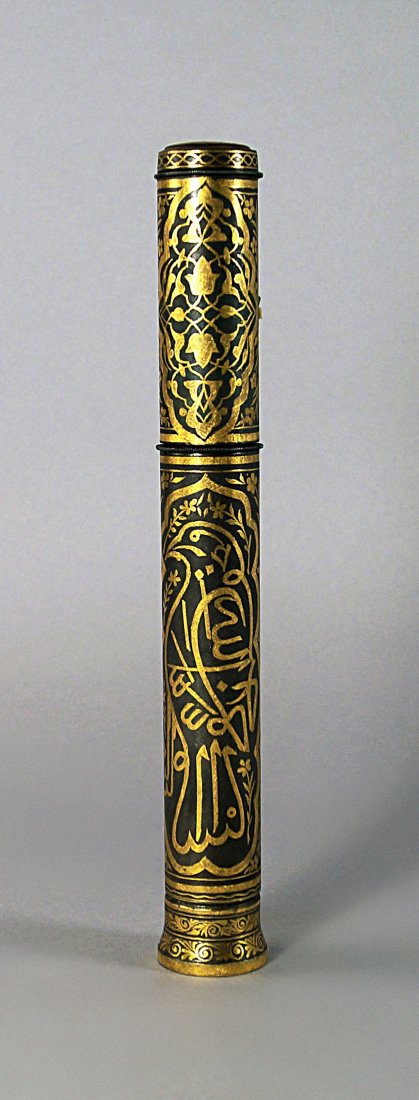 A Turkish Ottoman damascened qualandum, the ends: A Turkish Ottoman damascened qualandum, the ends decorated with foliage and interlacing, the body with lobed cartouches of a bird and foliage separated by flowering sprigs, 25cm high