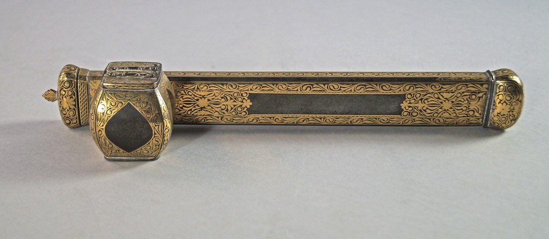 An Islamic Qajar gold damascened travelling inkwell pen: An Islamic Qajar gold damascened travelling inkwell pen holder case or scribe's tool, Indo-Persian, Mid 19th Century, finely decorated with continuous stylised scrolling gilt foliage, 29cm wide