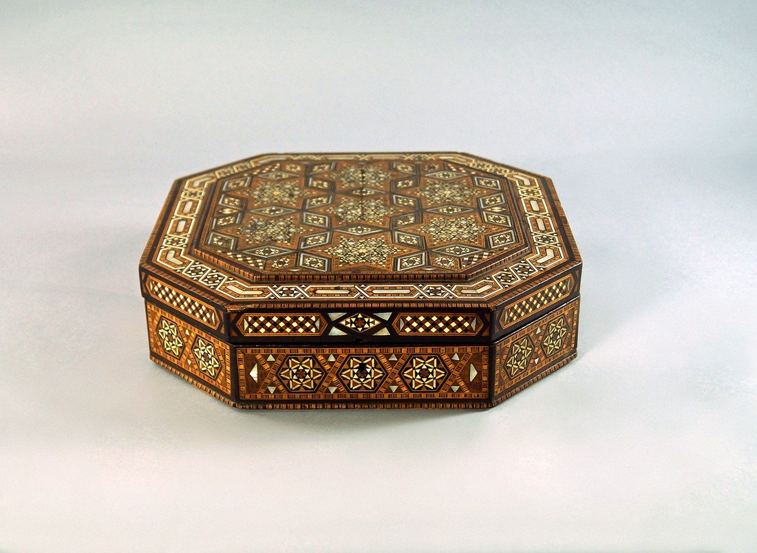 A Middle Eastern hexagonal mother of pearl and ivory: A Middle Eastern hexagonal mother of pearl and ivory inlaid box, later 19th/early 20th century, overall decorated with geometric patterning, the interior lined with silk, 31.5cm wide