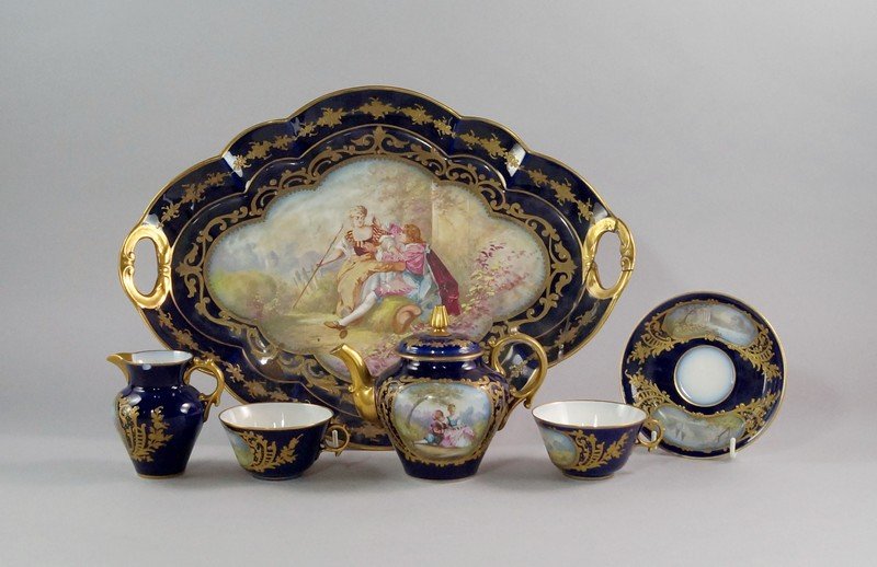 A Sevres porcelain part cabaret set, 19th century,: A Sevres porcelain part cabaret set, 19th century, painted with reserves of courting couples in the Rococo revivalist taste and landscapes, within tooled gilt borders, printed marks to base, to compri